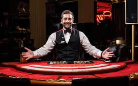 Mobile interface showing live baccarat table lobby with bet limits and player count